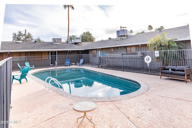 view of swimming pool with a fenced in pool, a patio, and fence