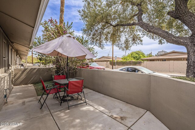 view of patio with outdoor dining area and fence private yard