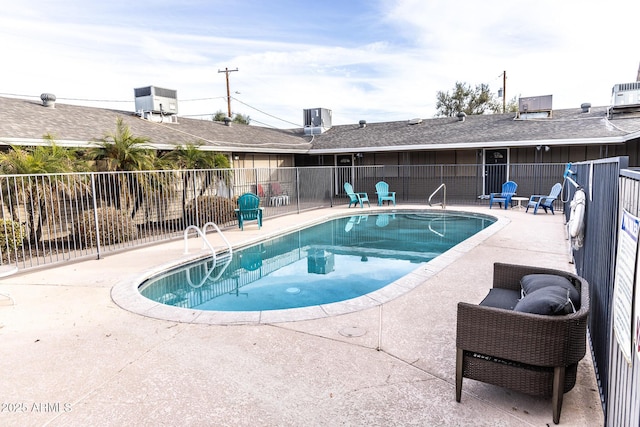 pool with fence, central AC, and a patio