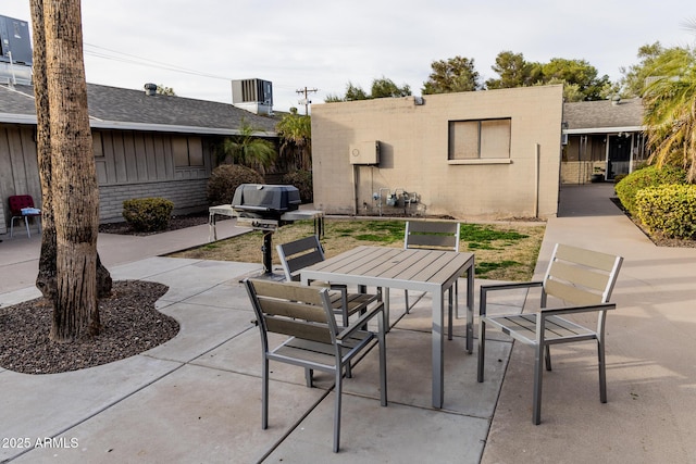 view of patio with outdoor dining area, grilling area, and cooling unit