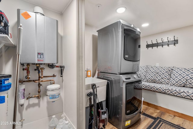 7500 E Old Walnut Canyon Rd, Flagstaff, AZ 86004 - washroom with stacked washer and clothes dryer, wood finished floors, laundry area, recessed lighting, and water heater