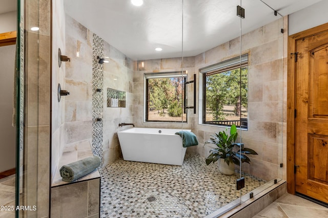 7500 E Old Walnut Canyon Rd, Flagstaff, AZ 86004 - bathroom with tile patterned floors, tile walls, a tile shower, and a freestanding bath