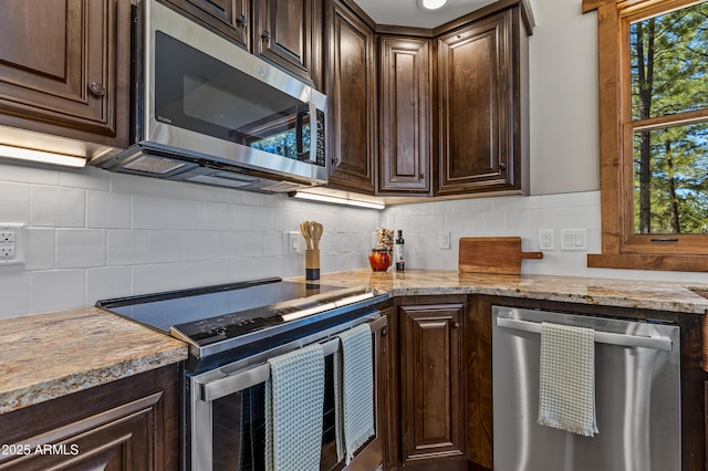 7500 E Old Walnut Canyon Rd, Flagstaff, AZ 86004 - kitchen with dark brown cabinetry, stainless steel appliances, and backsplash