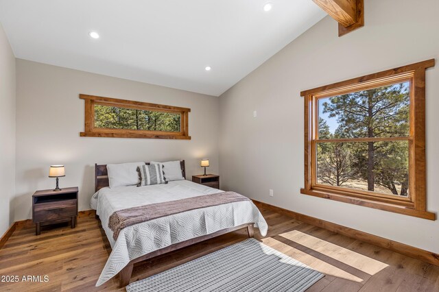 7500 E Old Walnut Canyon Rd, Flagstaff, AZ 86004 - bedroom featuring vaulted ceiling with beams, wood finished floors, and baseboards