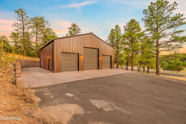 7500 E Old Walnut Canyon Rd, Flagstaff, AZ 86004 - garage at dusk featuring fence and a garage