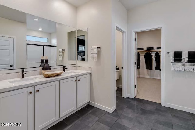 bathroom with vanity and a shower with door