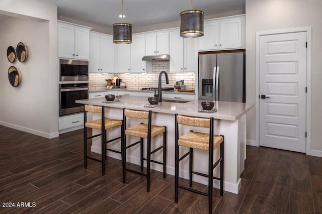 26966 N 168th Ln, Surprise, AZ 85387 - kitchen featuring stainless steel appliances, dark wood-type flooring, under cabinet range hood, backsplash, and baseboards