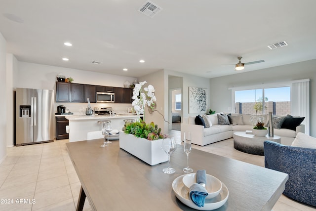 tiled dining room featuring ceiling fan