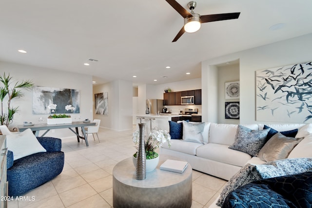 living room with light tile patterned flooring and ceiling fan