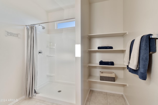 bathroom featuring tile patterned floors and walk in shower