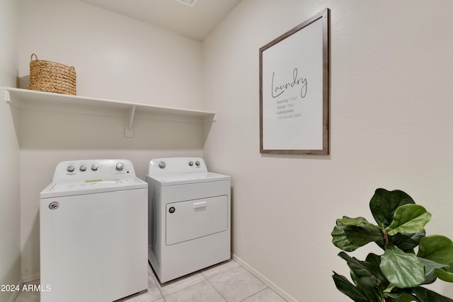 washroom with washing machine and dryer and light tile patterned floors