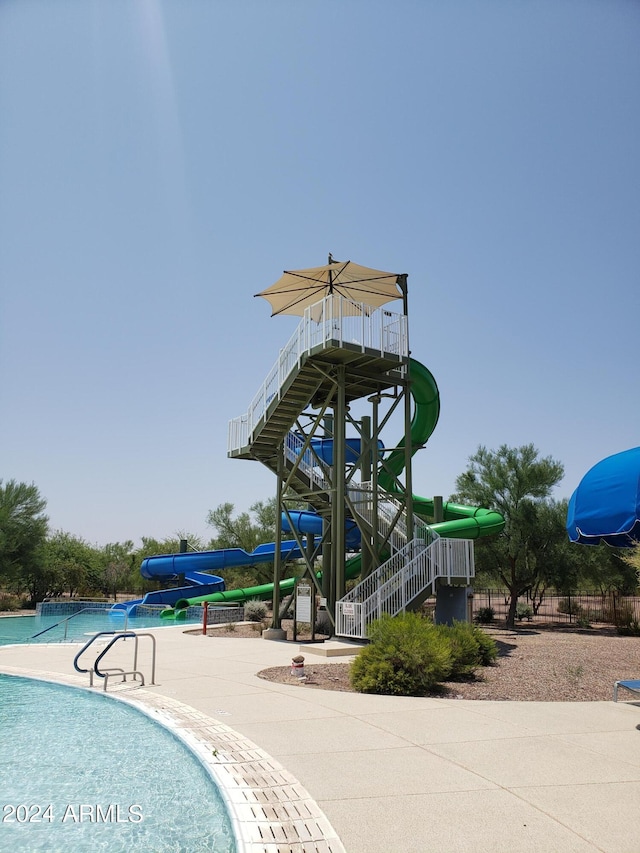 view of pool featuring a playground