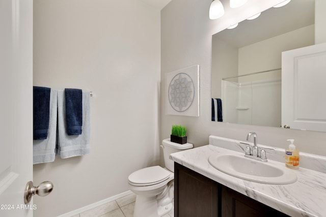 bathroom featuring tile patterned flooring, vanity, toilet, and walk in shower