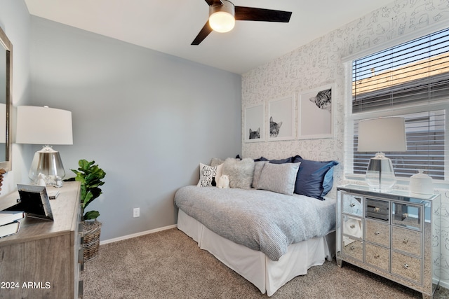 bedroom featuring light carpet and ceiling fan