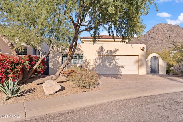 view of front of property featuring a mountain view and a garage