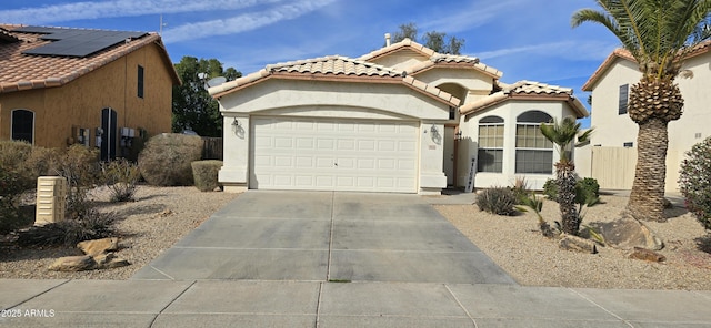 view of front of house featuring a garage and solar panels