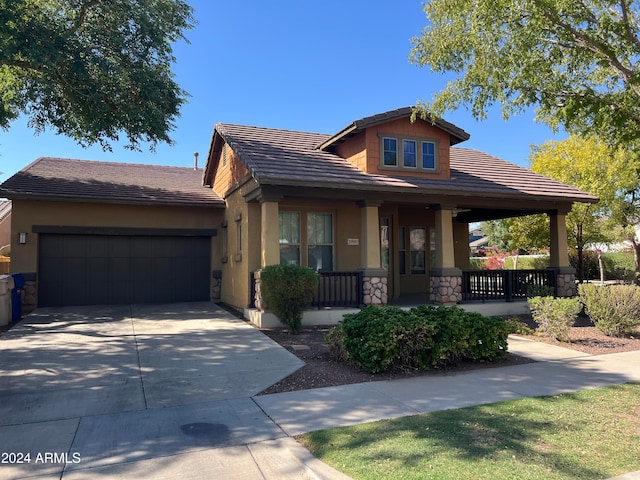 craftsman house with a garage and a porch