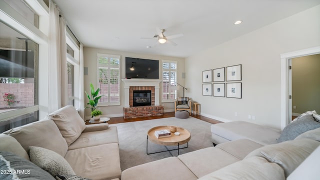 living room featuring wood finished floors, recessed lighting, a fireplace, and baseboards