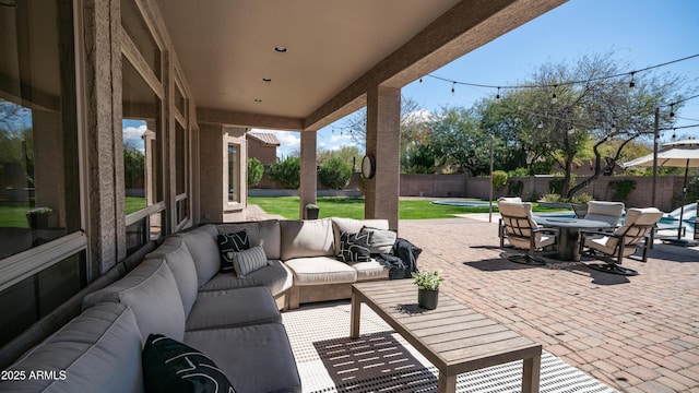 view of patio featuring outdoor dining area, a fenced backyard, and outdoor lounge area