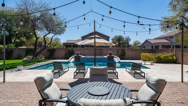 view of swimming pool featuring a patio, a fenced backyard, and a pool with connected hot tub