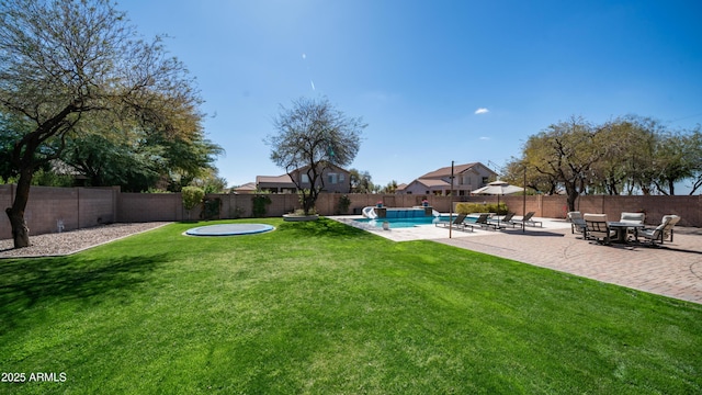 view of yard featuring a patio area, a fenced in pool, and a fenced backyard