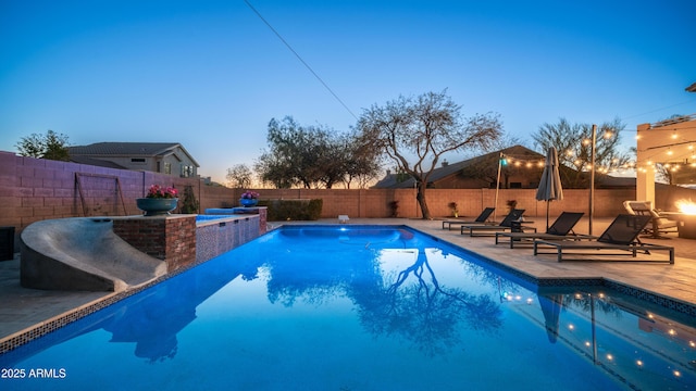 view of swimming pool with a fenced in pool, a fenced backyard, and a patio area