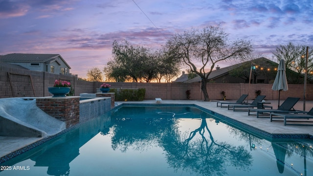 view of pool featuring a fenced backyard, a fenced in pool, and a patio