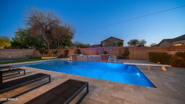 view of swimming pool with a fenced backyard, a fenced in pool, a patio, and a diving board