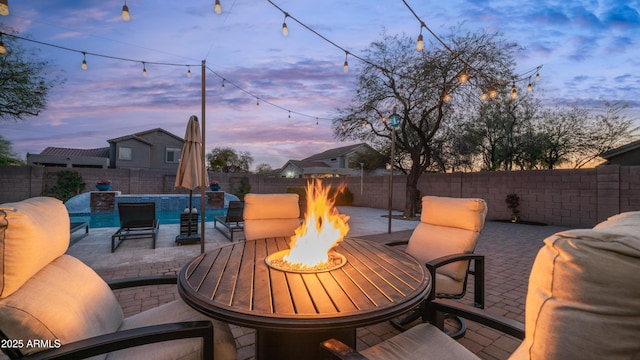 view of patio / terrace featuring a fenced in pool, an outdoor living space with a fire pit, and a fenced backyard