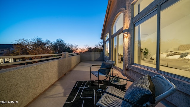 view of balcony at dusk