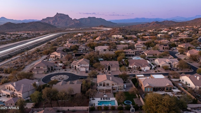 aerial view at dusk with a residential view and a mountain view