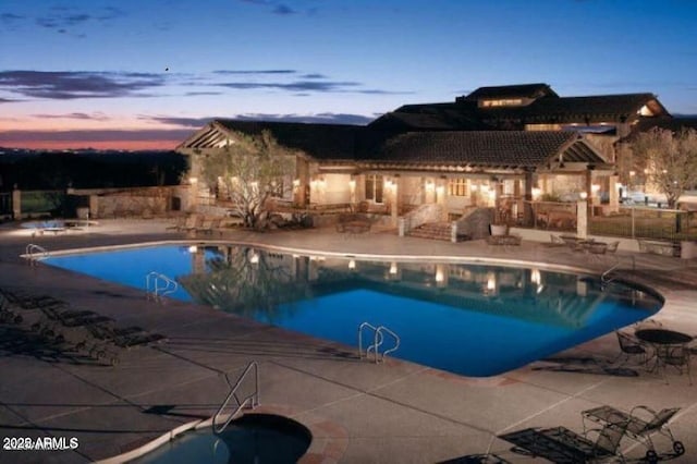 view of swimming pool featuring a fenced in pool, an in ground hot tub, and a patio