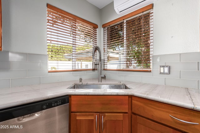 kitchen with sink, tasteful backsplash, dishwasher, and a wall mounted AC