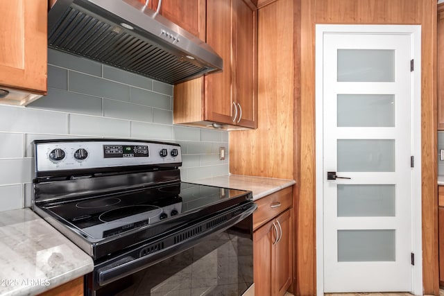 kitchen with light stone countertops, tile patterned floors, electric range oven, exhaust hood, and tasteful backsplash