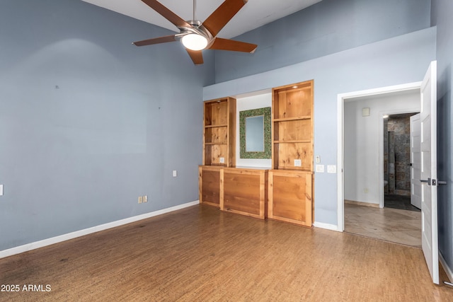 unfurnished bedroom featuring ceiling fan, high vaulted ceiling, and hardwood / wood-style flooring