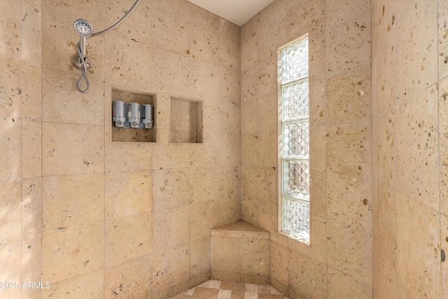 bathroom with tiled shower