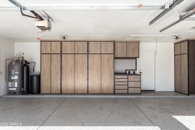 garage featuring a garage door opener and water heater