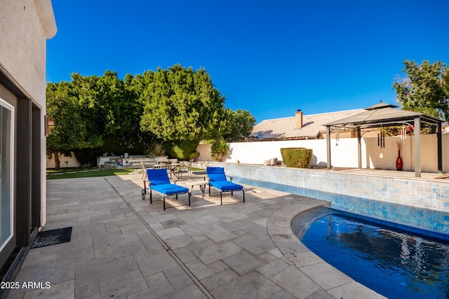 view of swimming pool with a patio and a gazebo