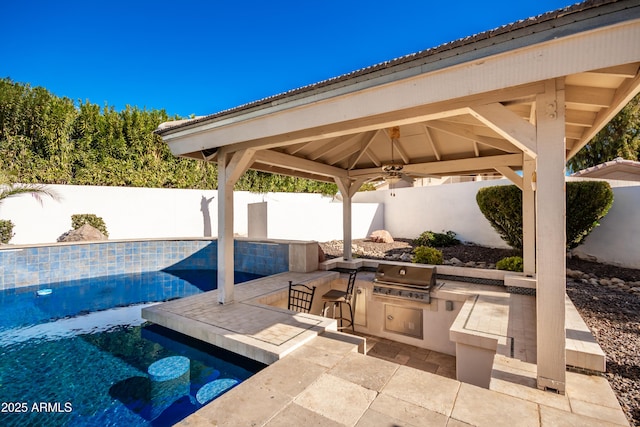 view of patio with a gazebo, exterior bar, area for grilling, a grill, and a fenced in pool