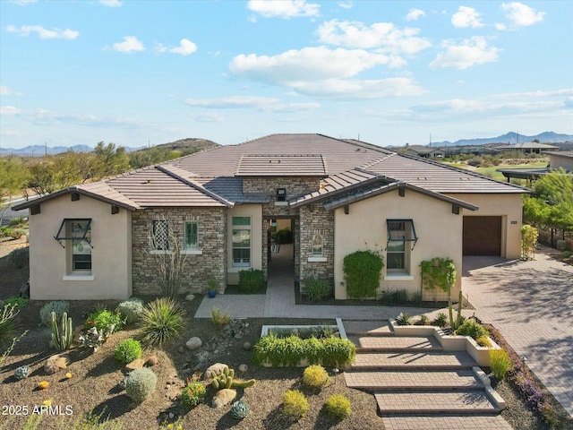 17413 E Hidden Green Ct, Rio Verde, AZ 85263 - view of front facade with decorative driveway, stucco siding, a tiled roof, and stone siding