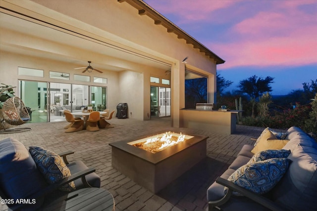 17413 E Hidden Green Ct, Rio Verde, AZ 85263 - view of patio with outdoor dining area, an outdoor living space with a fire pit, an outdoor kitchen, and a ceiling fan