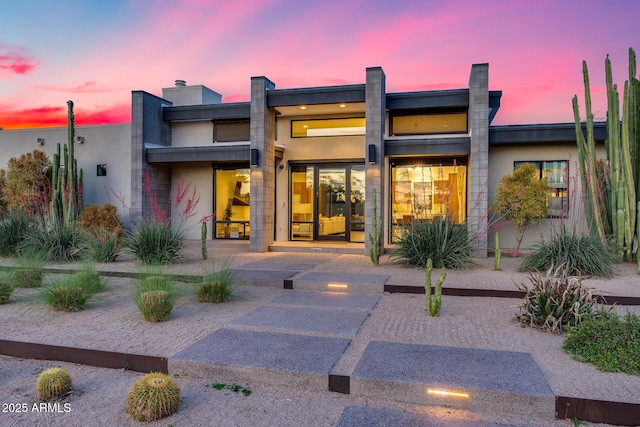 view of back of house at dusk