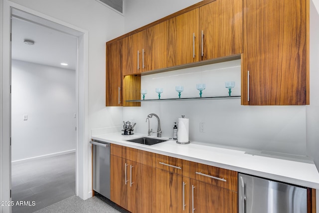 kitchen with a sink, modern cabinets, and brown cabinets