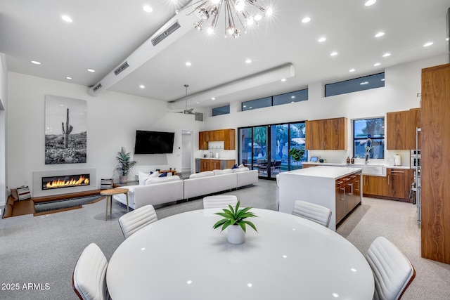 dining space featuring visible vents, recessed lighting, a high ceiling, and a notable chandelier