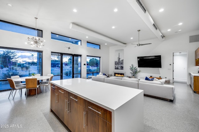 kitchen featuring visible vents, a kitchen island, light speckled floor, modern cabinets, and recessed lighting
