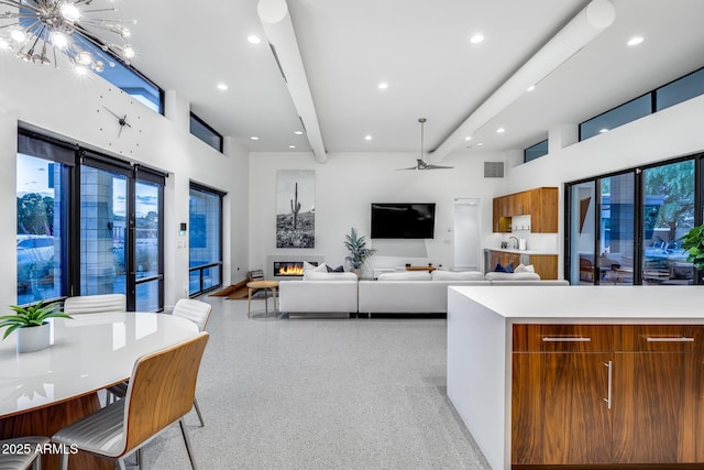 kitchen featuring brown cabinetry, visible vents, modern cabinets, light speckled floor, and beamed ceiling