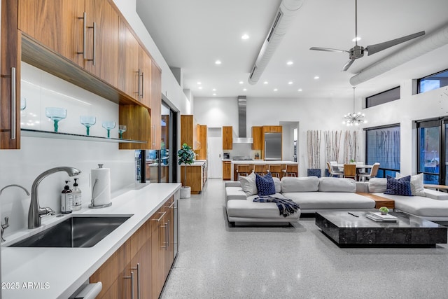 kitchen with brown cabinets, a sink, stainless steel built in refrigerator, and modern cabinets