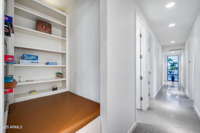 hall with baseboards, recessed lighting, and speckled floor
