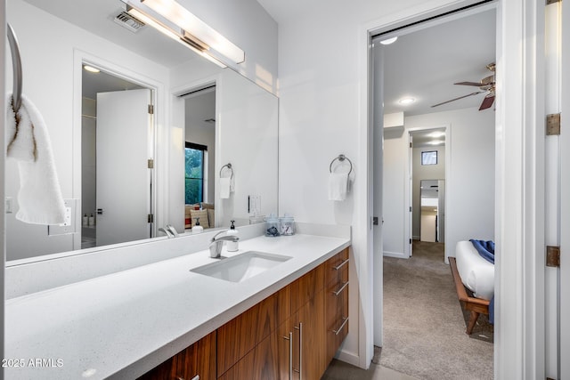 bathroom featuring ceiling fan, visible vents, baseboards, and vanity