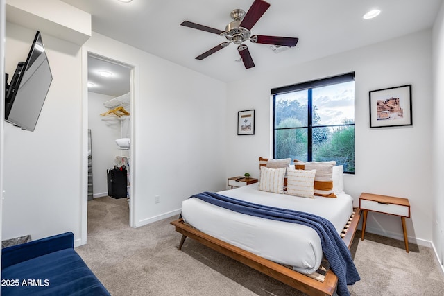 bedroom featuring ceiling fan, a walk in closet, carpet floors, recessed lighting, and baseboards